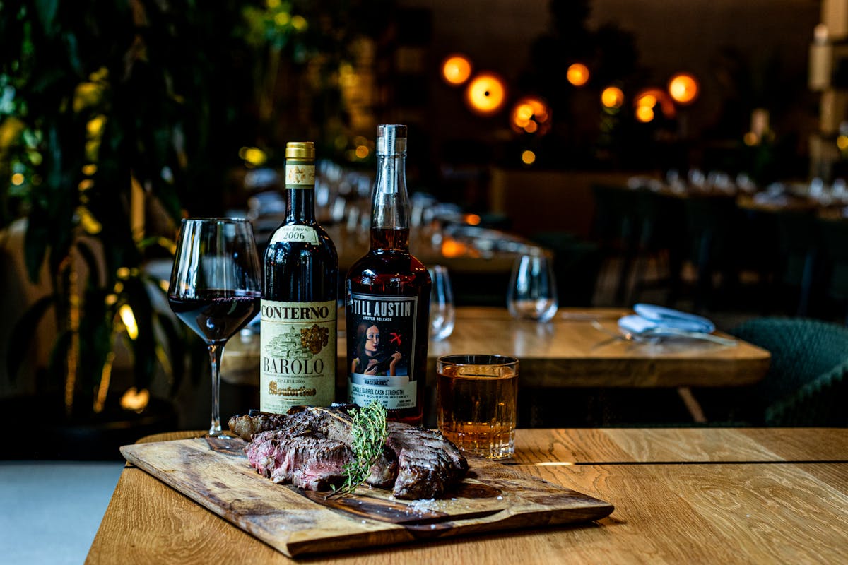 a bottle of wine sitting on top of a wooden table