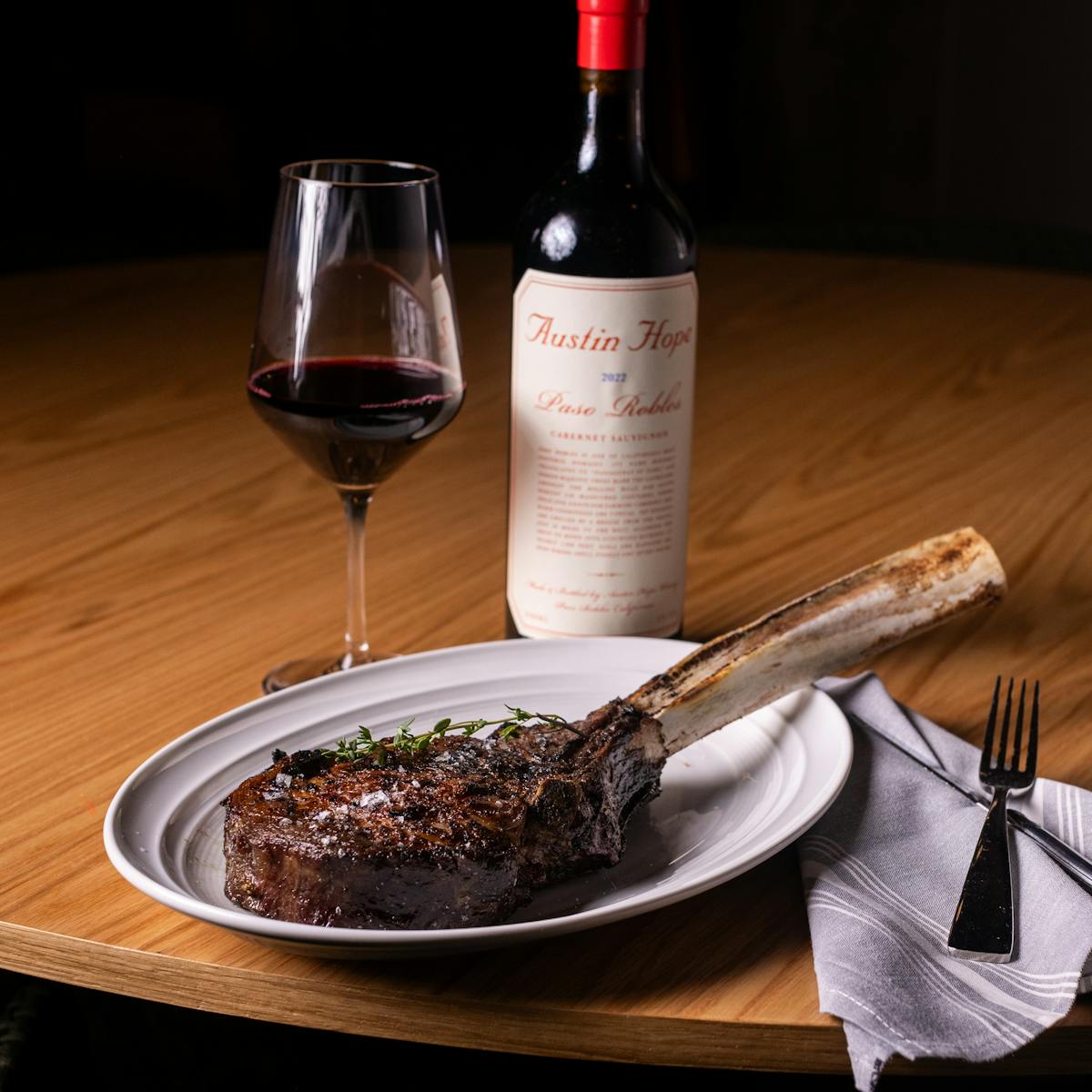 a bottle of wine sitting on top of a plate of food