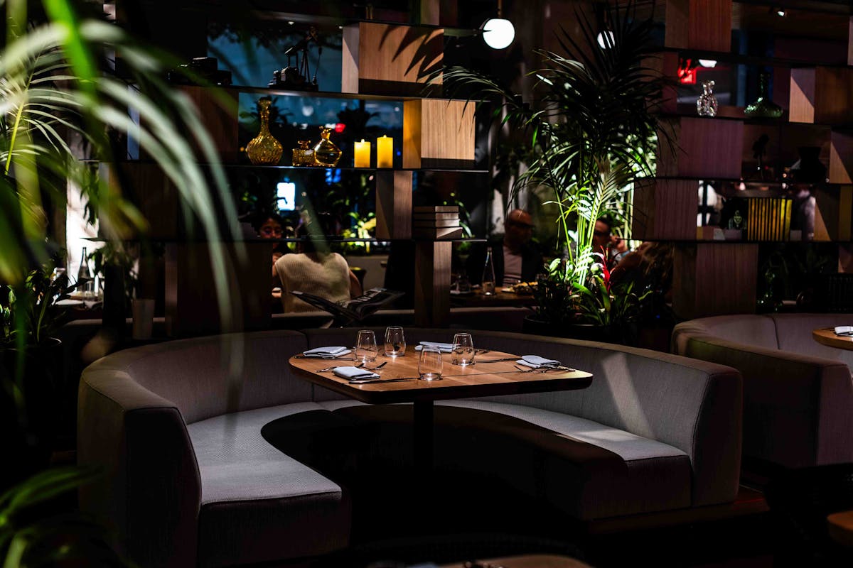 a living room filled with furniture and vase of flowers on a table