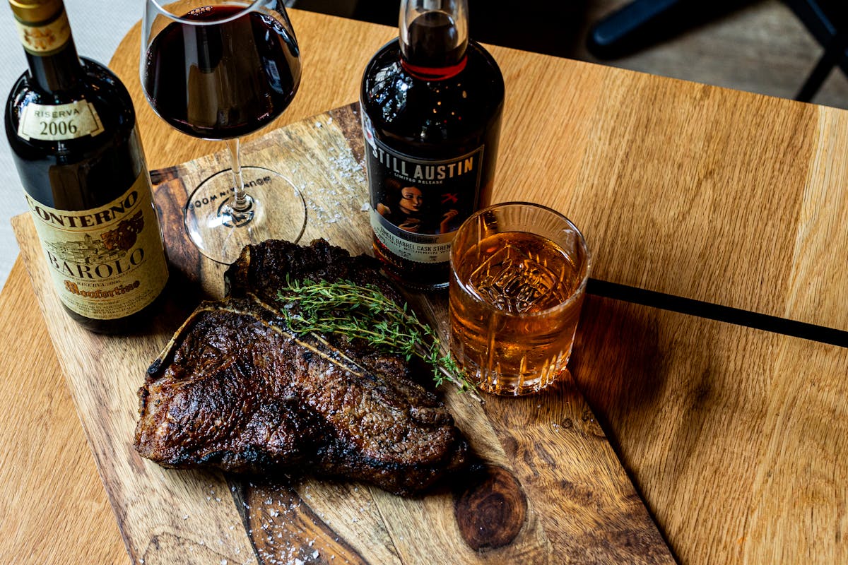 a bottle of wine sitting on top of a wooden table