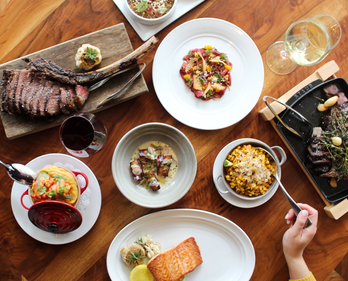 a group of people sitting at a table with a plate of food